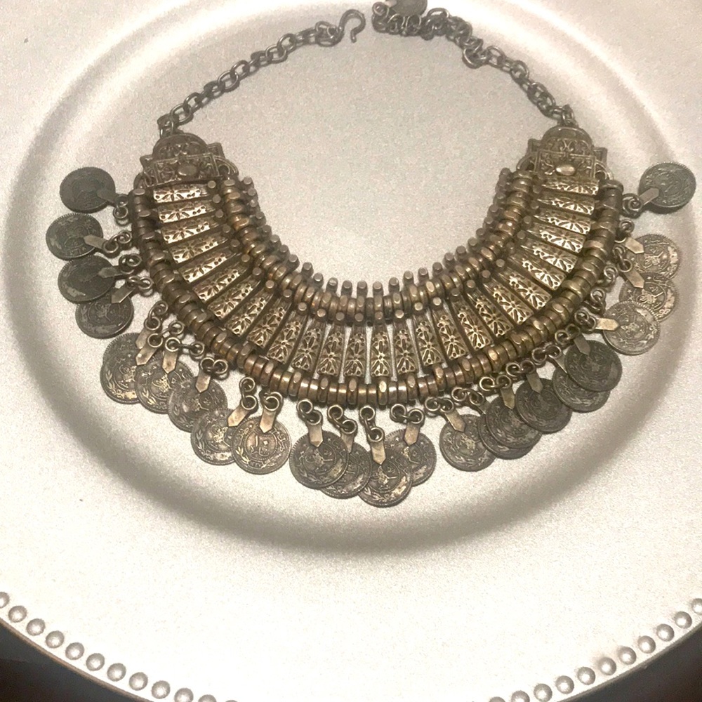 We’re selling a silver necklace that looks like it has coins on it